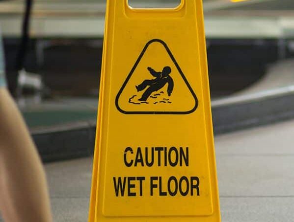 Yellow "Caution Wet Floor" warning sign.