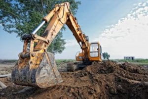 Construction crane digging a hole