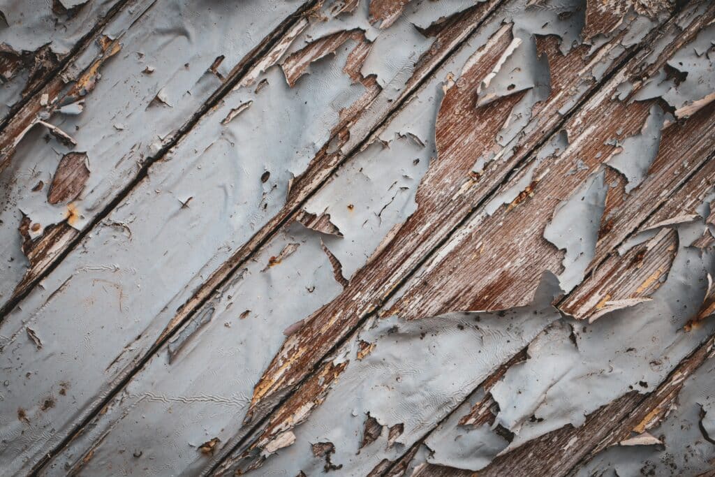 Peeling lead paint on weathered wood siding